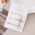 Set di 3 fermagli dorati con perle bianche e fiocco di strass su cartoncino di marca - Combinazione Fiocco