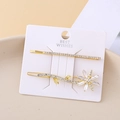 Set of two gold daisy hair clips with clear rhinestones on a white display card - Daisy Combination