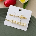 Set de barrettes dorées avec perles en cœur et nœud en strass sur plateau vert - Or Combo Cœur