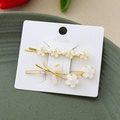 Détails de barrettes florales avec perles et strass sur une carte de présentation - Or Combo Fleurs 2