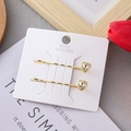 Elegant gold-tone hair clips with heart-shaped crystals on card backing - Heart / 2 Pcs/Set / Gold