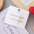 Close-up of two gold-plated hair clips with oval crystals on a white display card - Ellipse / 2 Pcs/Set / Gold