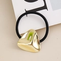 Detail of a black elastic hair tie with a polished gold irregular triangle metal charm - Gold Triangle Buckle