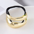 Detail of gold minimalist curved metal ornament on elastic high-stretch black hair tie - Gold Double Connected