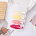 Set van vier glanzende haarspelden in crème, geel, roze en bordeauxrood op een witte kaart - Glanzende Boog Jelly Kleur