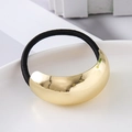 Detailed close-up of large golden curved metal element on elastic hair tie with mirror finish - Gold Round Smooth