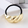 Macro detail of elastic hair tie with polished gold croissant textured metal ornament - Gold Twist Croissant