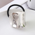 Detail of minimalist irregular wavy silver metal ornament on a black elastic hair tie - Silver Irregular Oval