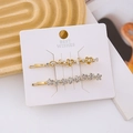 Detail of two gold floral hair clips with sparkling rhinestones on a display card - 2PCS / Display Set 1 (17 PCS)