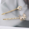 Detailed close-up of cat paw and kitten hair clips with gold base and enamel finish - White