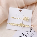 Detail view of two gold hair clips with cat-eye resin butterflies on a display card - Butterfly Combination