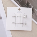 Détail de barrettes argentées lune et étoile avec strass sur une carte de présentation - Style Étoile Lune Argent