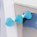 Detailed close-up of light blue glitter shell hair clip with pearls and golden metal base - Blue Pearl Shell Style B