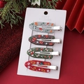 Nahaufnahme von vier festlichen Weihnachts-Haarspangen mit Weihnachtsmann- und Rentier-Motiven - Silberne Kombination A