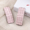 Close-up of pink houndstooth tweed hair clips with detailed woven texture and elegant style - Pink Rectangular