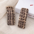Close-up detail of vintage houndstooth pattern tweed hair clips on rustic linen fabric - Coffee Rectangular