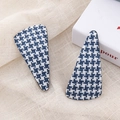 Detailed view of blue and white houndstooth triangular hair clips on textured linen - Blue Triangle