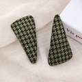 Close-up of green houndstooth pattern fabric hair clips on a soft beige linen background - Green Triangle