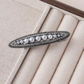 Detail of elegant oval hair clip featuring grey pearls and dark rhinestones on a metal base - Grey Pearl Oval Pave Style