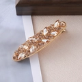 Detail view of champagne rhinestone hair clip with elegant golden alloy leaf patterns - Champagne Rhinestone Cross Leaf Style