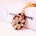 Brown enamel Easter egg keychain with golden floral patterns and white rhinestones - Brown