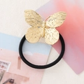 Minimalist elastic hair tie featuring a textured golden metal butterfly charm on black band - Gold Butterfly