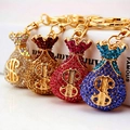 Sparkling crystal money bag keychains in gold, silver, red, and blue with dollar sign - Random Color