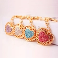Sparkling rhinestone heart keychains in four colors with gold hollow metal frames - Random Color