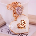 Elegante gouden metalen hartvormige sleutelhanger met emaille, roos en glanzende strass-stenen - Wit