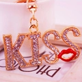 Sparkling rhinestone KISS letter keychain with a red lip charm and golden finish metal ring - Red