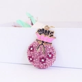Pink crystal rhinestone lucky money bag keychain with golden base and floral design - Pink