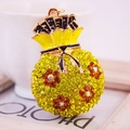Lucky money bag keychain with yellow crystals and orange floral details on white background - Lemon Yellow