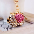 Gold pig keychain with white rhinestones and pink heart detail on a white background - Pink