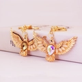 Golden eagle keychain with champagne crystals and opal-style wings on white box - Random Color