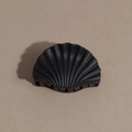 Close-up of matte black shell-shaped hair claw clip with multi-tooth grip and refined texture - Shell / Black