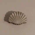 Close-up of scallop-shaped hair claw clip in mocha brown with matte finish and radial texture - Shell / Khaki