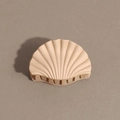 Close-up of elegant apricot shell shaped matte hair claw clip with smooth shark teeth detail - Shell / Nude