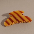 Detail of tortoiseshell acetate hair claw with Barrette La France gold lettering - Yellow-Brown Stripes