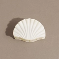 Detail view of the shell-shaped hair claw clip in matte cream finish with sturdy teeth - Shell / Off White