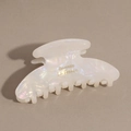 Close-up of marble acetate hair claw clip with golden Barrette La France lettering - Iridescent White