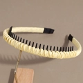Close-up of light yellow fabric headband showing anti-slip teeth and woven texture - Yellow