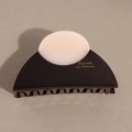 Detail of semicircular acetate hair claw clip in dark brown with gold brand lettering - Dark Brown