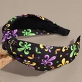 Detail view of knotted fabric headband with purple, green, and gold fleur-de-lis patterns - Black Fleur-de-lis Style