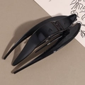 Detail view of the sleek black high-gloss swallowtail hair claw clip in a 45-degree angle - Black