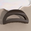Detail view of large matte dark brown hollow crescent shark hair claw clip for bun hairstyles - Brown