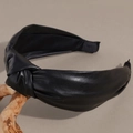 Close-up of black faux leather headband featuring an elegant twisted knot design - Black