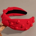 Red top knot headband with 3D heart beads on a minimalist knitted fabric design - Red