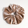 Macro shot of champagne gold velvet scrunchie showing soft pleated texture and metallic sheen - Khaki