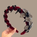Detailed shot of burgundy velvet headband featuring rhinestone flowers and black beads - Rhinestone Flower Red
