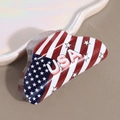 Close-up of USA flag mini hair claw clip with glitter finish and bold white text - Triangle Round USA